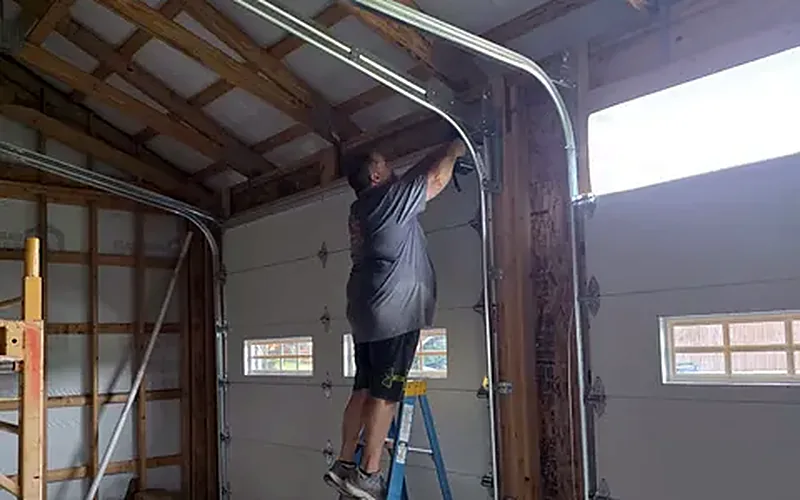 Garage door track and spring installation in progress